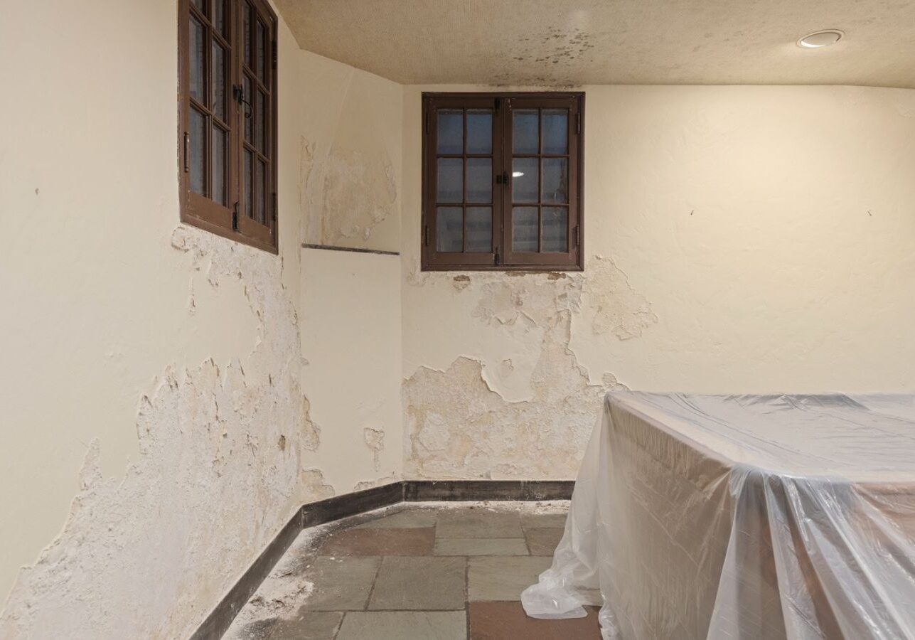 Loft Drywall & Plaster expert restoring cracked plaster wall in Upper St. Clair, PA with precision tools. Plaster Repair Near Me
